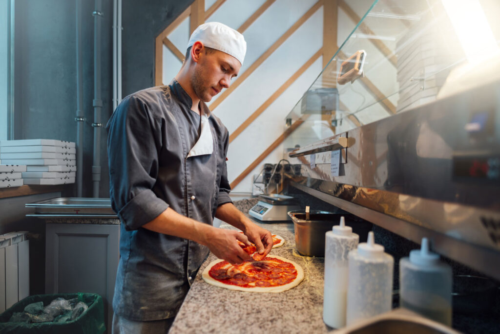 Chef making a pizza.